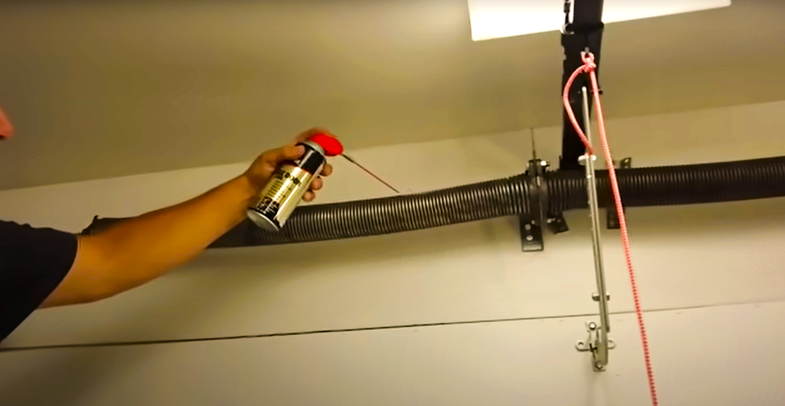 Technician performing garage door spring repair in Coral Springs