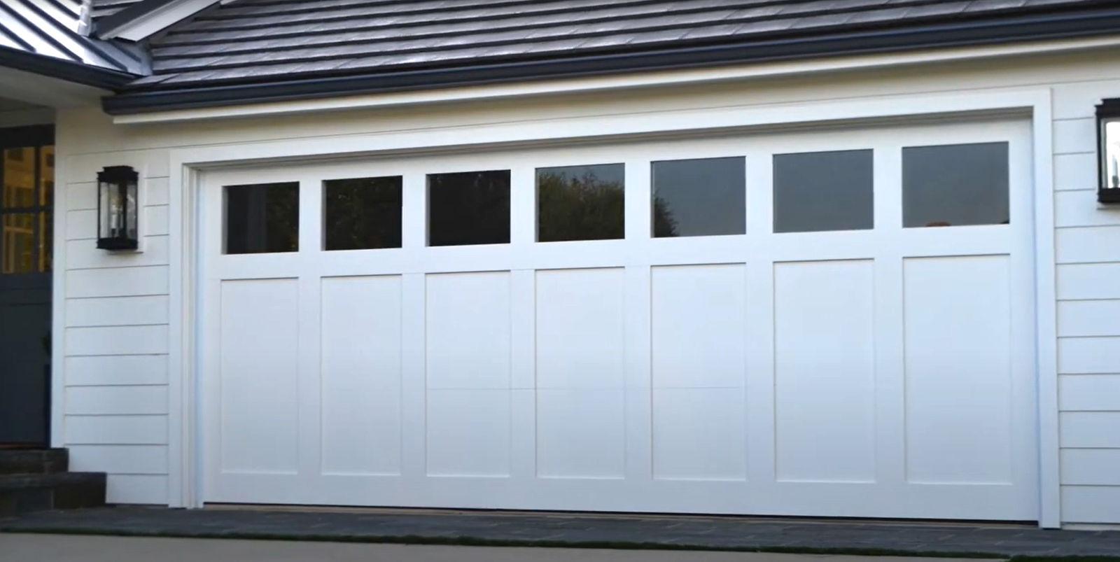 Technician providing same-day garage door repair service in Coral Springs, adjusting and fixing a residential garage door system