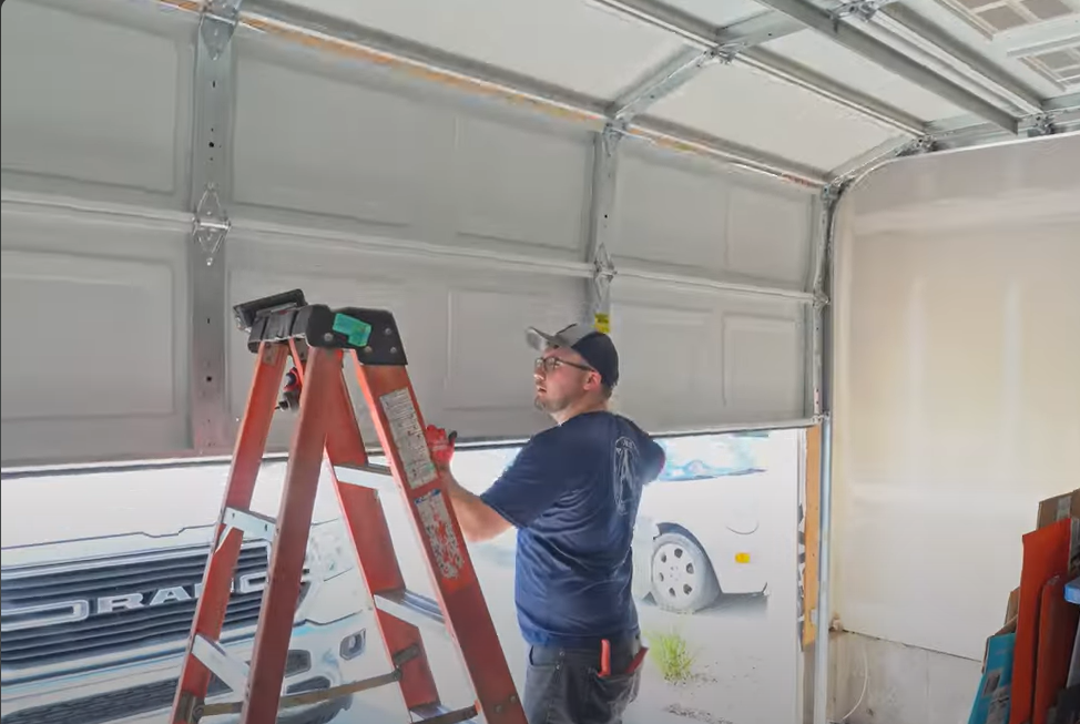 Technician repairing a residential garage door in Coral Springs, highlighting professional local garage door repair services