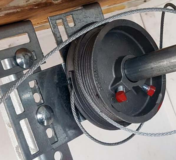 Close-up of a damaged garage door cable in need of repair in Coral Springs